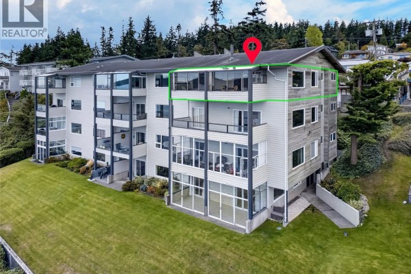 Side view of a multi-story apartment building with balconies and glass-enclosed areas. - 13 523 Island Hwy, Campbell River