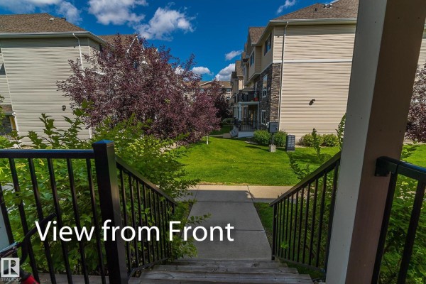 View from top of front steps looking down at a paved walkway and green lawn. - #13 7289 South Terwillegar Dr Nw, Edmonton