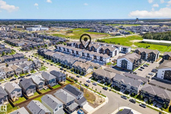 Aerial view of a suburban neighborhood with rows of townhouses and houses. - #13 850 Secord Bv Nw, Edmonton