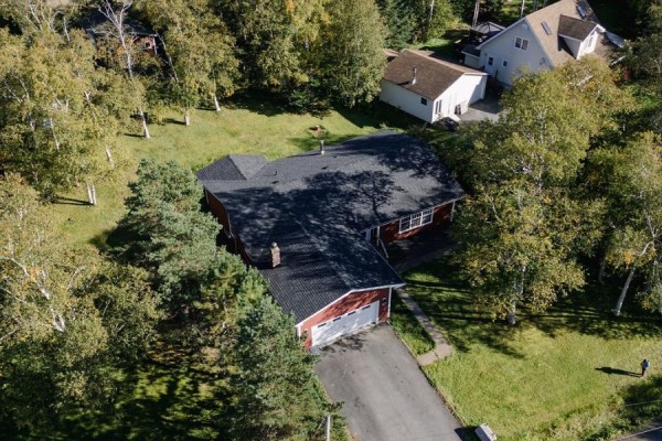 Aerial view of red siding house with attached garage and neighbouring houses. - 13 Chippy's Lane, Appleton