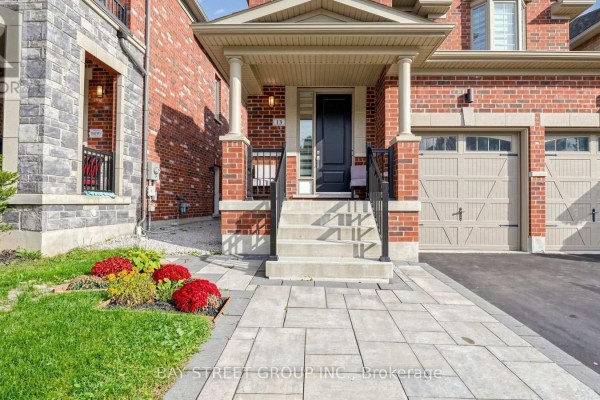 Close-up of the front entrance with stairs, a black door, and a planter. - 13 Micklefield Avenue, Whitby
