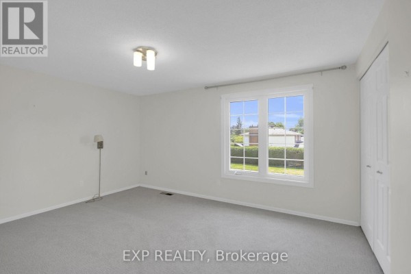 Living room with carpet and a large window - 13 Shanel Place Ottawa