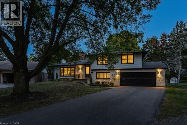 Side exterior view of 13 Southwick Place showing the driveway and garage at dusk. - 13 Southwick Place, Waterloo