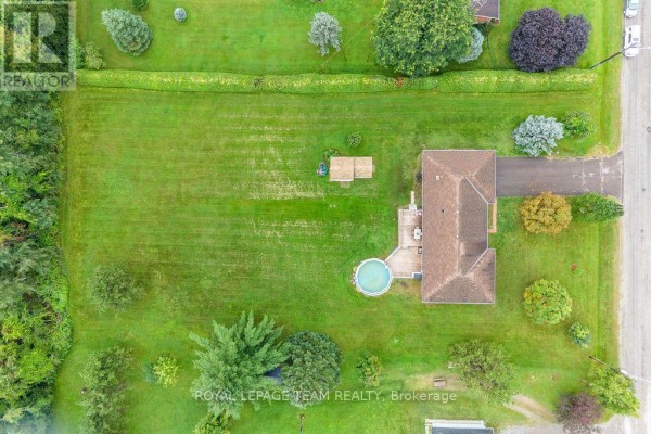 Aerial view of house with pool, deck, shed, and green lawn - 13 Springfield Drive Whitewater Region