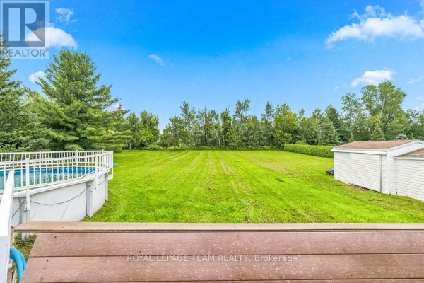 Above-ground pool and large green lawn with shed - 13 Springfield Drive Whitewater Region