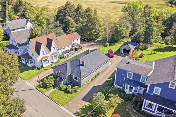 Aerial view of houses on a tree-lined street, showing a grey house with a metal roof. - 13 Squire Street, Sackville