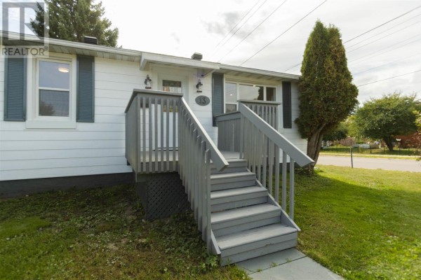Close-up of the grey wooden stairs leading to the front entrance of a white house. - 13 Stevens St, Sault Ste  Marie