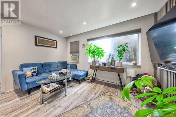 Dining area with gray table and chairs, two lounge chairs, and wall art. - 13 Teston Boulevard, Toronto