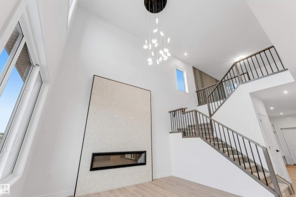 Kitchen featuring white and wood cabinetry, marble countertops, and built-in shelving. - 13 Trill Pt, Spruce Grove