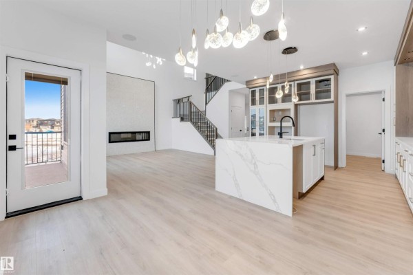 Detailed kitchen with marble island, wine storage, and pendant lights above the countertop. - 13 Trill Pt, Spruce Grove