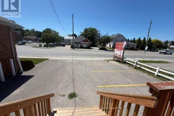 Commercial kitchen with stainless steel countertops and cooking equipment. - 13 Yonge Street S, Springwater