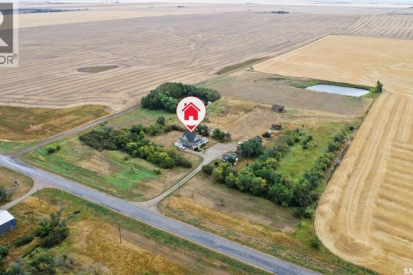 Aerial view showing the house, outbuildings, and agricultural fields on the 13.04-acre property. - 13.04 Acreage By Lake Diefenbaker, Canaan Rm No  225