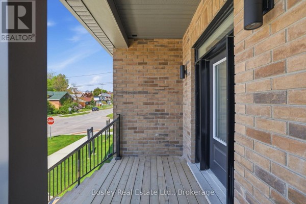 View from the covered porch of the house, looking towards the street. - 130 Fifth Street, Collingwood