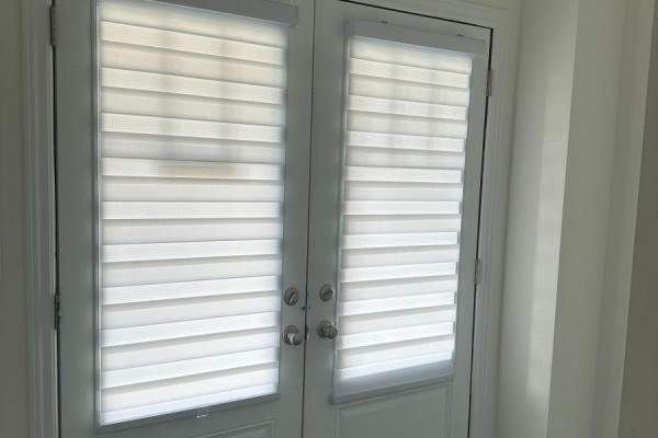 Interior view of a double door with white horizontally slatted blinds. - 130 Sapphire Way, Thorold