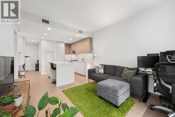 Bedroom with a king-sized bed, grey bedside table, white doors, and carpeted floor. - 1301 2186 Gilmore Avenue, Burnaby