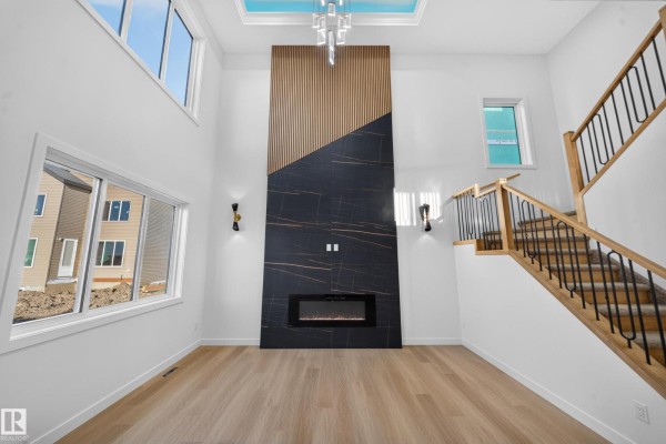 Spacious entryway with double glass doors, a white bench, and a large window. - 13024 186 Avene Nw, Edmonton