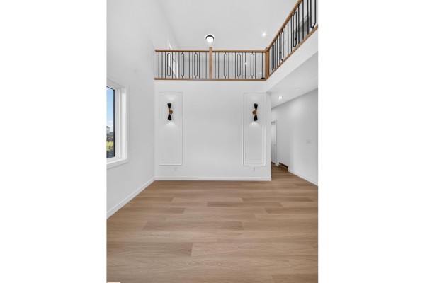 Bedroom with light wood floors, a window, and a closet with double doors. - 13024 186 Avene Nw, Edmonton