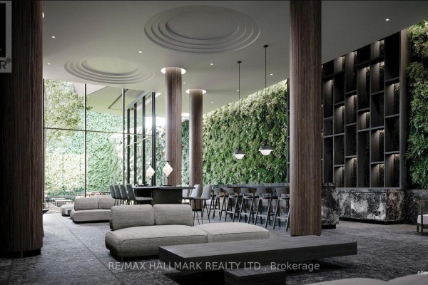 Lobby area with modern seating, a bar, and a large living green wall. - 1303 - 120 Broadway Avenue, Toronto