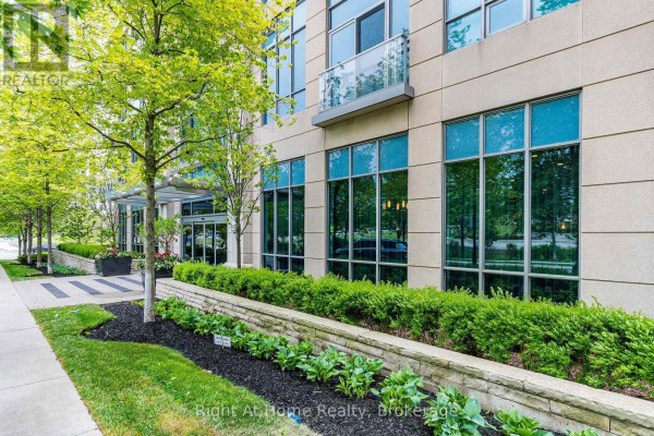 Exterior of apartment building with large windows and manicured landscaping. - 1303 - 15 Viking Lane, Toronto