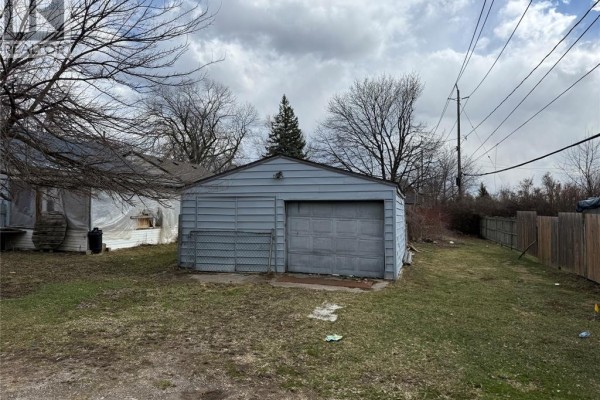 Detached garage with sectional door and chain-link fence - 1303 Central Windsor