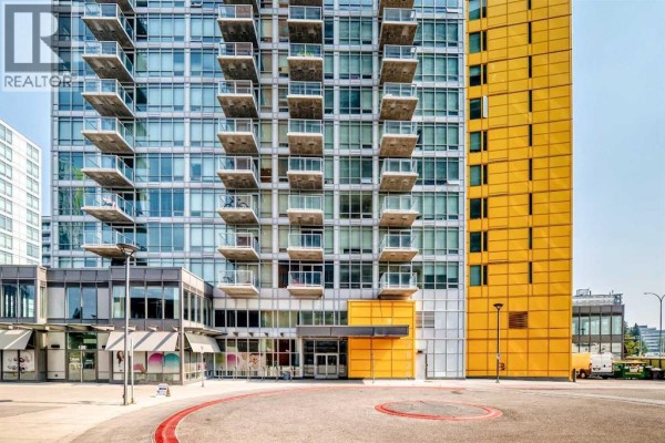 Close-up of the facade of modern apartment buildings, showing balconies and yellow panels. - 1304, 3820 Brentwood  Nw, Calgary