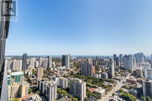 Expansive view of Toronto's buildings and streets under a bright blue sky. - 1304 - 55 Charles Street E, Toronto