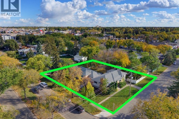Aerial view of a property with three houses and surrounding neighborhood. - 1304/1308/1312 Main Street, Saskatoon