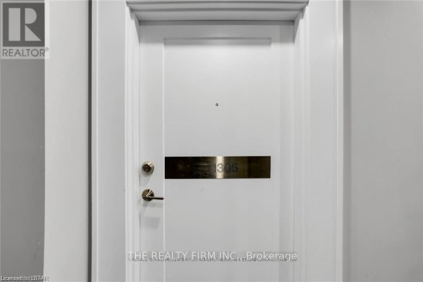 Close-up view of the apartment door labeled "1305" with a gold plaque. - 1305 - 505 Talbot Street, London East
