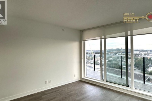 View of the living room area with a large window overlooking the city and water. - 1305 1401 Hunter Street, North Vancouver