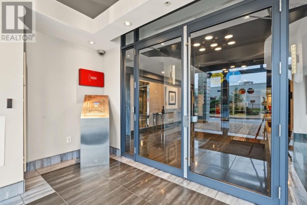 Building entrance with large glass doors, marble tile floor, and a metal display stand. - 1305 3471 Dutch Village Road, Halifax