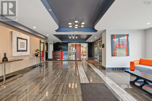 Building lobby with a reception desk, elevators, modern art, and glossy tile flooring. - 1305 3471 Dutch Village Road, Halifax
