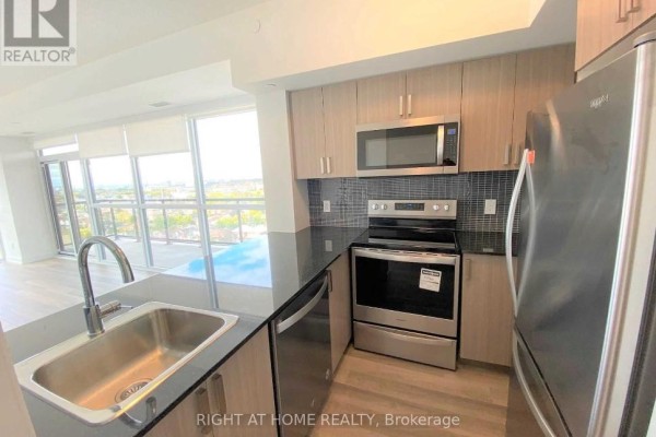 Contemporary kitchen with light wood cabinets, stainless steel appliances, and granite countertops. - 1308 - 1603 Eglinton Avenue W, Toronto