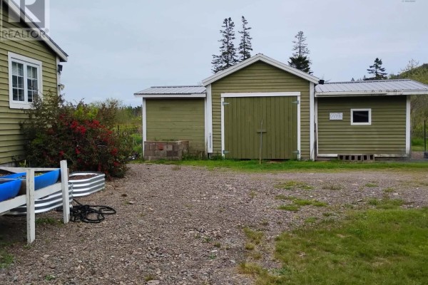 Kitchen with grey cabinets, red appliances, and a drop-leaf table with chairs. - 1308 Cape D'or Road, Advocate Harbour