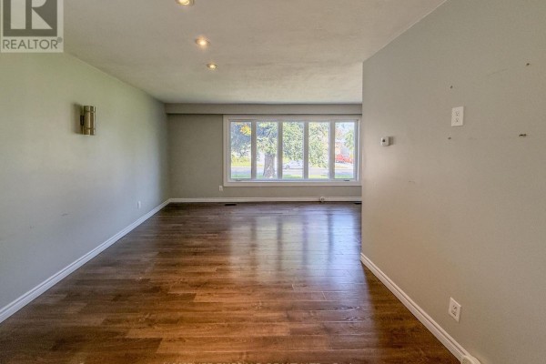 Living room with hardwood floors and a large picture window. - 131 Cundles Road E, Barrie