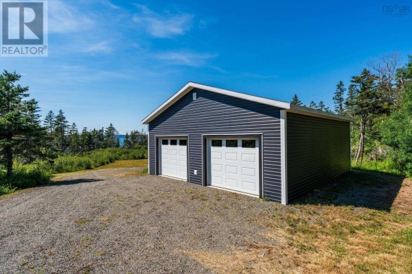 Dark blue garage with two white doors and a gravel driveway. - 131 Doty Branch, Ashmore