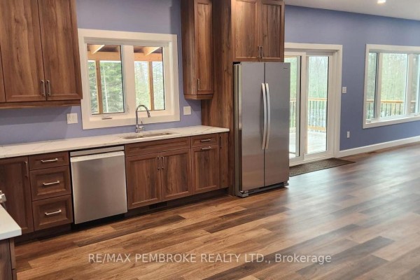 Kitchen featuring dark wood cabinets, stainless steel appliances, a gas stove, and a dishwasher. - 131 Island View Drive, North Algona Wilberforce