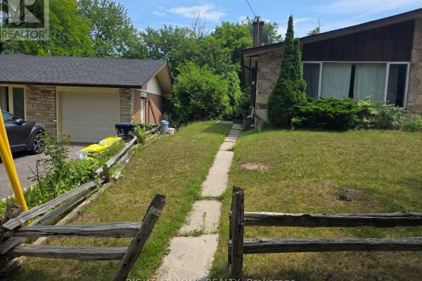 Pathway leading up to the front entrance of a house with a stone and wood exterior. - 131 Thicketwood Drive, Toronto