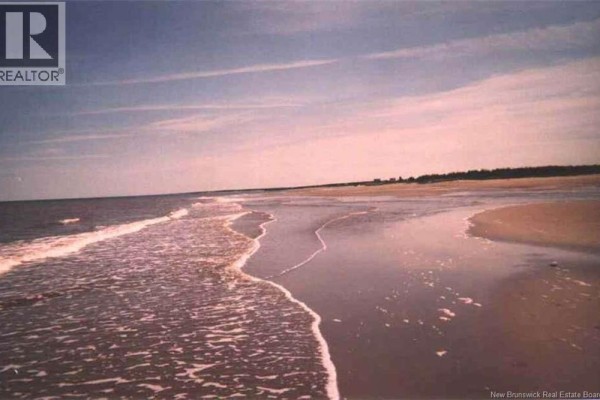 Ocean waves breaking on the beach with a clear blue sky - 1310 Route 505, Sainte Anne De Kent