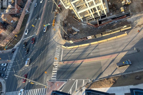 High-angle view of an intersection with cars, crosswalks, and a construction site. - 1313 - 260 Malta Avenue, Brampton