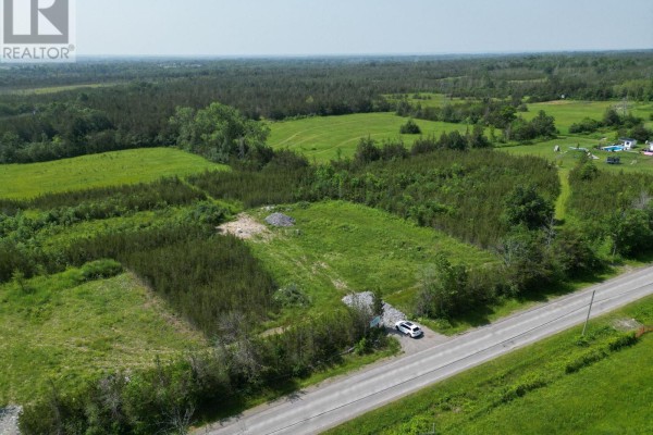 Aerial view of rural land with road frontage, cleared areas, and distant tree lines. - 1314 Lazier Road, Tyendinaga