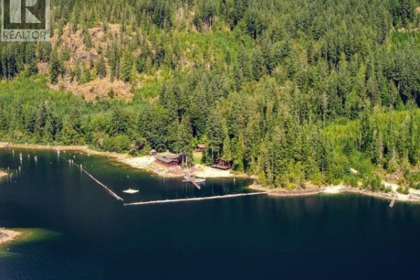 Aerial view of the property showing forested area, dock, and waterfront. - 13168 Powell Lake, Powell River