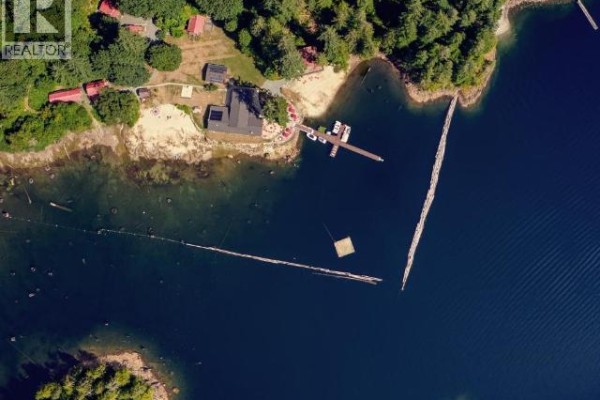 Aerial perspective of the shoreline, dock, and surrounding natural landscape. - 13168 Powell Lake, Powell River
