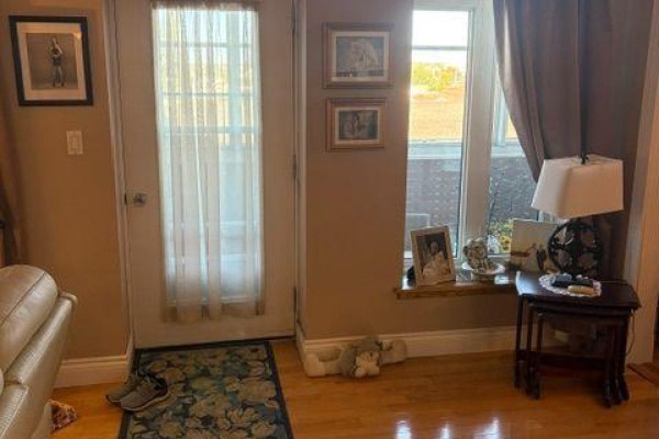 Living room interior with door, window, sofa, and side table. - 132 - 200 Wende Avenue, Timmins