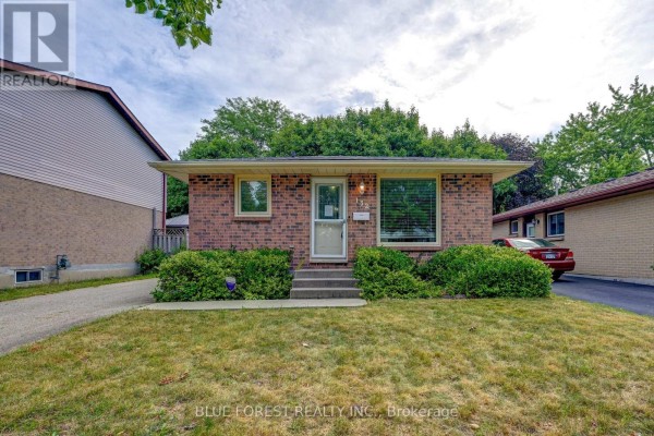 Street view of a brick bungalow with a paved driveway and lawn. - 132 Ardsley Crescent, London North
