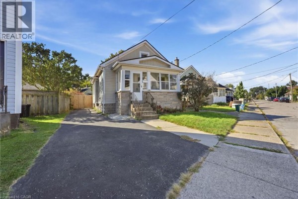 Side view of the bungalow from the driveway, with a street view in the background. - 132 Grass Avenue, St  Catharines