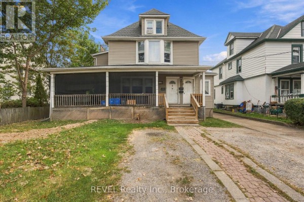 Close-up view of the main entrance to the multi-family home featuring two separate doors and mailboxes. - 132 Hellems Avenue, Welland
