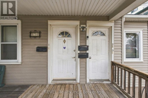 Detail of the two front doors of the multi-family home, numbered 1 and 2, with mailboxes. - 132 Hellems Avenue, Welland