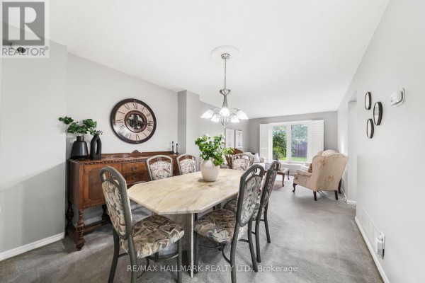 Interior hallway with tile flooring, mirrored closet doors, a staircase, and console table. - 1322 Redwood Lane, Pickering
