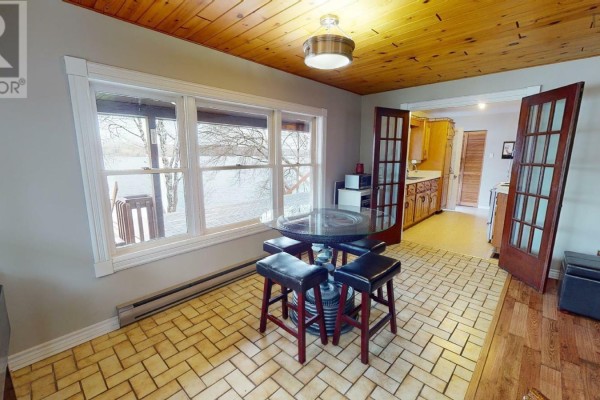 Bathroom with a toilet, vanity, sink, and a washing machine. - 13249 Nova Scotia 7 Highway, Aspen