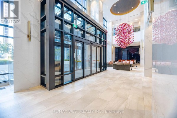 Double glass doors with a dark metal frame leading into a bright lobby. - 1327 - 5 Mabelle Avenue, Toronto